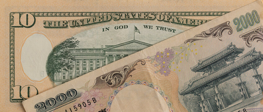 US 10 dollar banknote and Japanese 2000 yen banknote close up