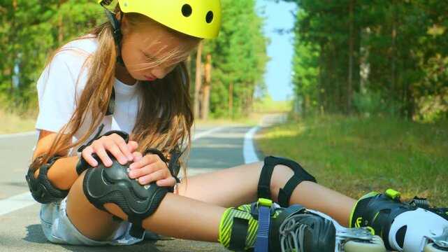 Knee injury and a girl on roller skates sitting on the floor outside. Sports, emergency medical care and a hurt leg after fall.