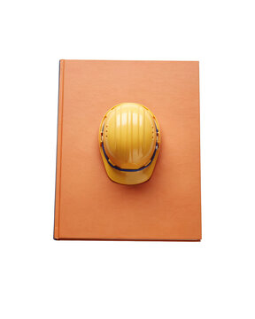 A smiling yellow hard hat sits on an orange square object.