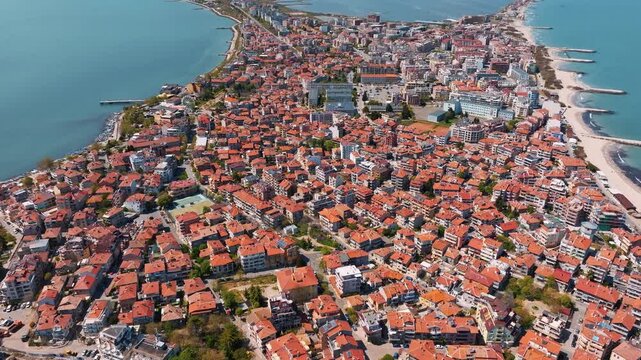 Pomorie old town high angle drone view traditional houses red tile roofs streets urban dense architecture sunny day summer holiday resort destination Burgas region Bulgaria background