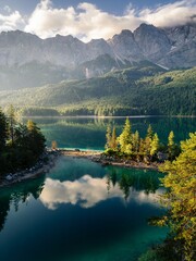 Scenic summer landscape of a calm turquoise alpine lake reflecting white clouds featuring a small pine tree island and majestic rugged mountains © Baby khan