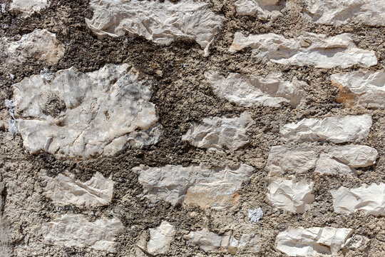 The background old gray stony wall