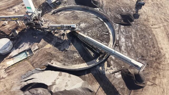 Aerial view of reclaimer machine processing coal at an industrial mining site