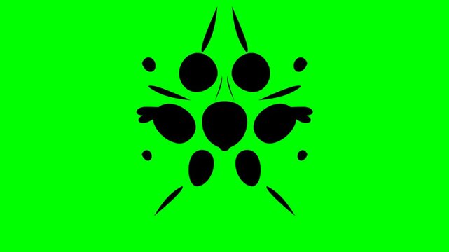 Symmetrical black ink blot monster shapes on green screen