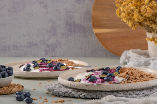 Healthy breakfast plates featuring creamy yogurt with berry compote and crispy cereal