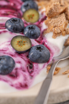 Healthy yogurt bowl with fresh blueberries and granola topping