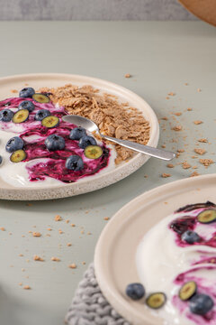 Healthy yogurt plates with berry compote and crunchy cereal