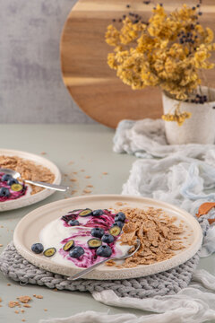 Healthy breakfast plates with yogurt berry compote and cereal