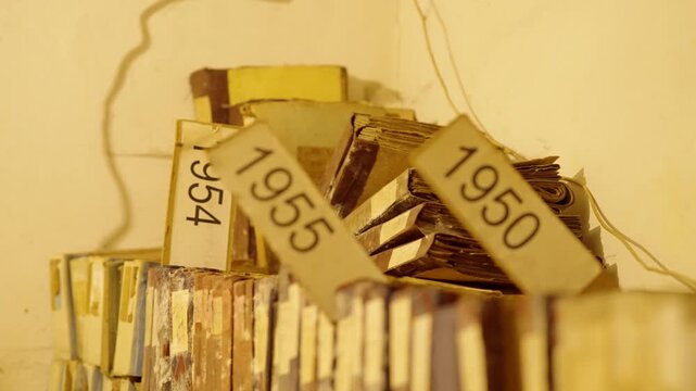 Old Vintage Folders With Years Tags On Shelves. Historic Documents Stacked Inside Storage. History Research 