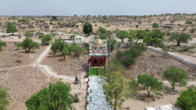 Drone footage of a mosque surrounded by the Thar Desert landscape in Pakistan