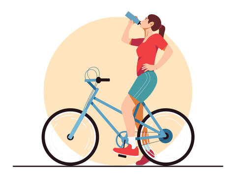 Woman riding bicycle and drinking water. Outdoor cycling and hydration concept.