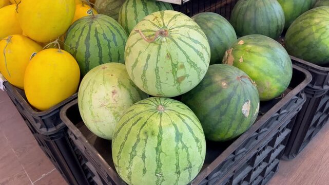 Close up of organic ripe watermelons and honey melons at grocery