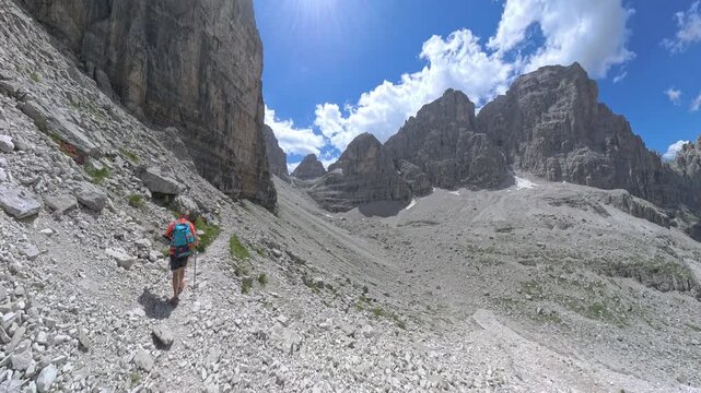 Mountain hiker approaching the Via Ferrata Bocchette Centrali near Bocca di Brenta, Dolomites, Italy