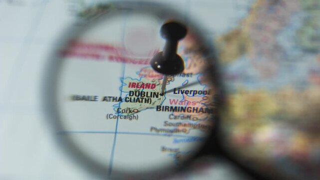 Finding Dublin on the printed map with a magnifying glass