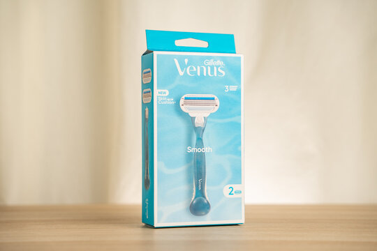 STRASBOURG, FRANCE - JULY 2, 2026 : Blue Gillette Venus razor packaging box photographed on a wooden table, highlighting women's shaving blades, retail packaging and branding for beauty, personal care