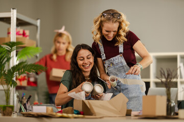 Obraz premium Women Packing Products at a Small Business Workspace During Day Time