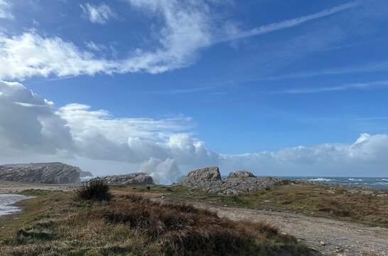 Atlantic waves break against the eroded Costa Quebrada coastline as shifting winter weather and approaching storm clouds shape the rugged coastal landscape of northern Spain.