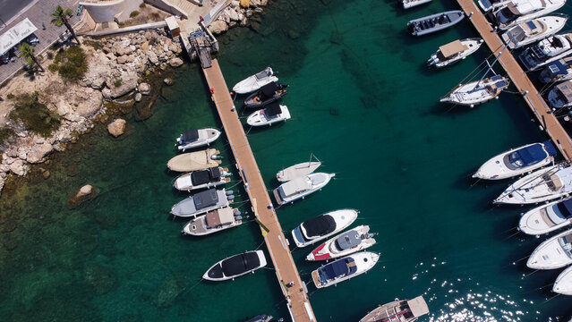 Drone view of boats mored in Mgarr harbour in Gozo Island, Malta.