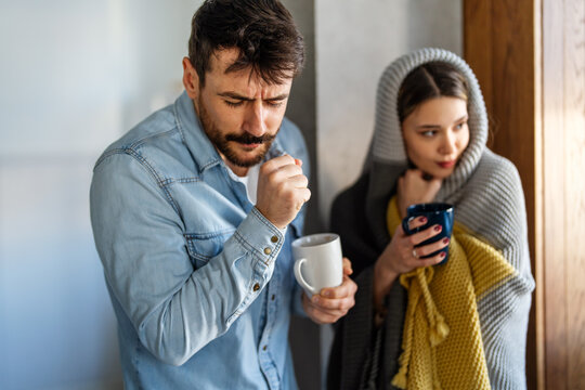 Wrapped in blankets, a couple faces emotional burnout and mental fatigue while supporting each other