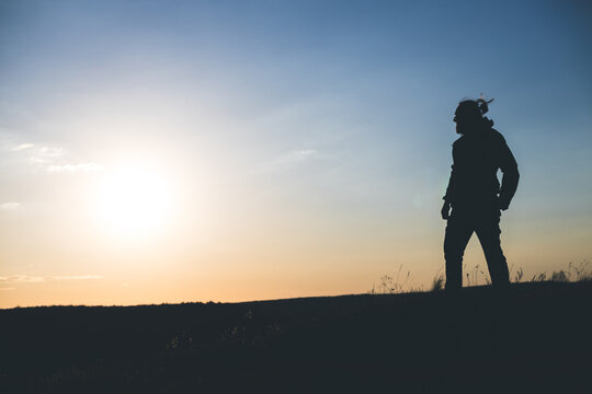 Confident Silhouette Standing Firm Against the Sunset Sky