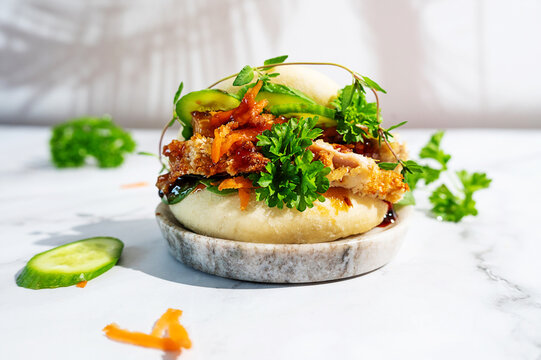 Trendy teriyaki chicken bao sliders on a stylish platter.