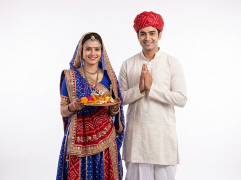 Traditional Rajasthani Couple Welcoming Guests with Aarti Thali on White Background