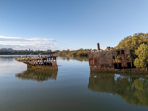 Shipwreck sections wiith rusty hull on sunny day. Wreck located in Homebush Bay, Parramatta river, Sydney Australia.
