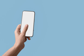 Fototapeta na wymiar Hand holding a modern smartphone with a blank white screen for app display on a light blue background, the device is presented against a light blue background, ideal for mobile applications