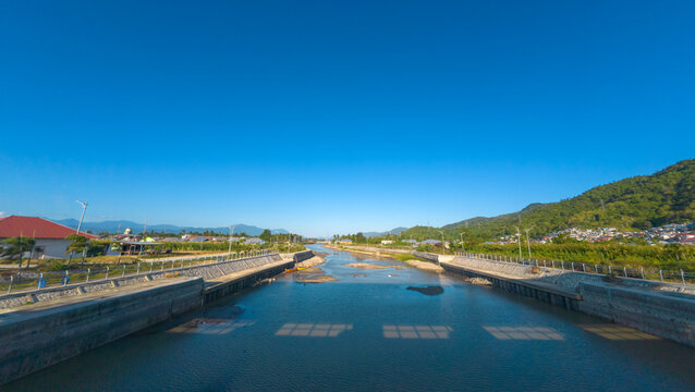 River Canal With Green Hills and Blue Sky