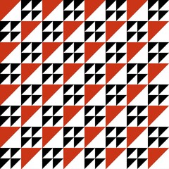 Obraz premium ​Modern geometric seamless pattern with red, black, and white triangles.