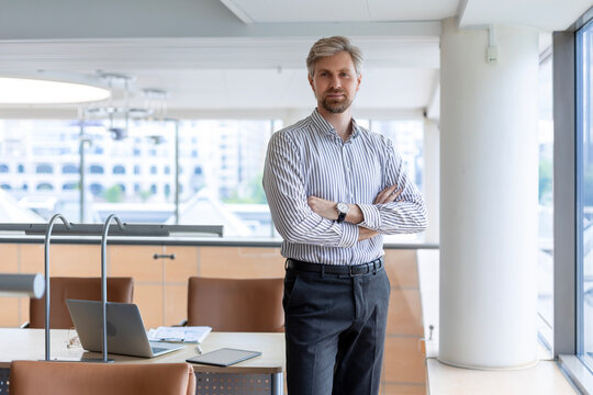 Modern business man in formalwear standing in open space office