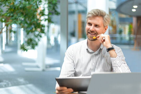 Happy young male customer support executive working in office.