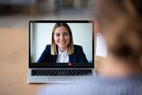 Video call on laptop screen with professional woman in online business meeting