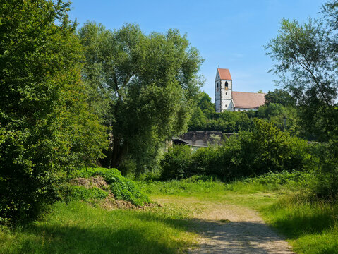 germany, historic st blasius church rising gracefully behind green trees beneath deep blue summer sky in charming plochingen city landscape