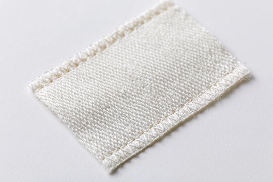 The Fabric Patch Closeup White Textured Cloth with Stitched Edges