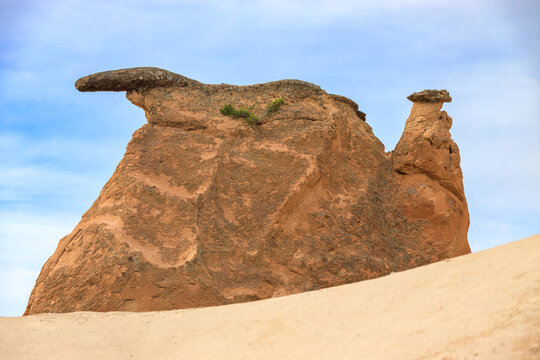 Close-up of bizarre rock formations against blue sky in the Devrent Valley or Imagination Valley in Cappadocia, Turkey. The rock was formed as a result of the erosion of volcanic rocks.
