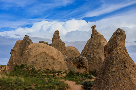 Landscape with bizarre rock formations against blue sky in the Devrent Valley or Imagination Valley in Cappadocia, Turkey. Popular tourist attraction at excursion