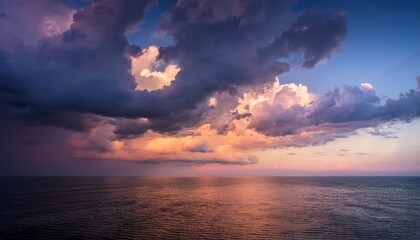 Fototapeta premium dramatic clouds with soft hues during twilight creating a serene atmosphere