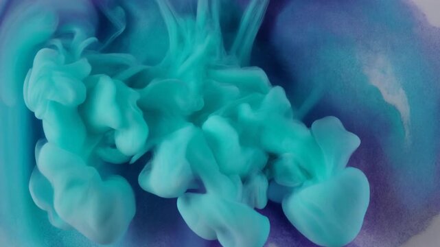Spreading watercolor pigments blooming in slow motion in turquoise and