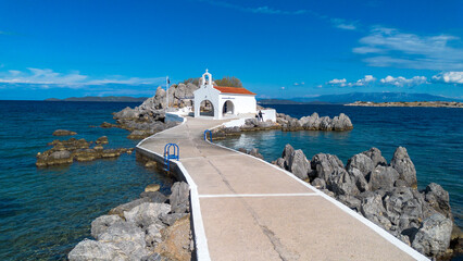 Fototapeta premium Aerial view of the chapel of Agios Isidoros on a rocky islet in Chios island Greece
