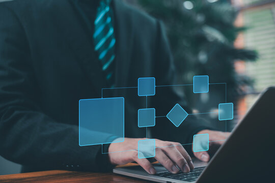 A business designs digital project diagrams on a laptop. Creating automated business process maps. Concepts include process management, algorithmic flow systems, and workflow planning