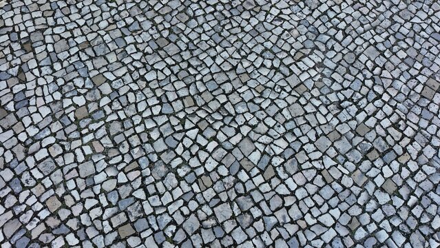 Close-up of black and white cobblestone pavement in traditional Portuguese style.