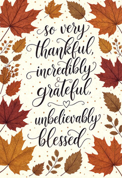 Beautiful autumn leaves background with thankful grateful and blessed handwritten text in elegant calligraphy design
