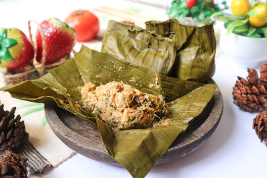 Botok, also known as bothok, a traditional Indonesian side dish of grated coconut mixed with prawn and tempeh, wrapped in banana leaves and steamed.