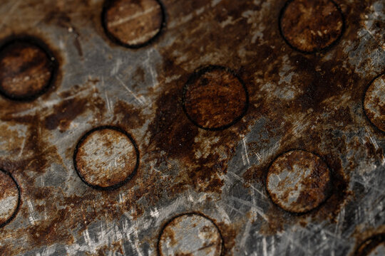 Close-Up of Rusted Metal Surface with Circular Pattern and Scratches