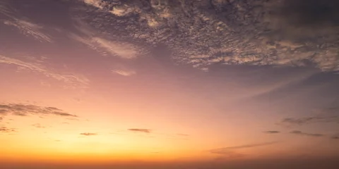 Beautiful sunset sky background with soft pastel purple clouds and bright golden orange sun glow for panoramic travel mockup design © Choat