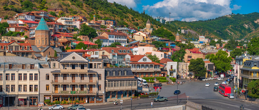 Old Tbilisi city panorama with Meidan square and red tour bus in Georgia