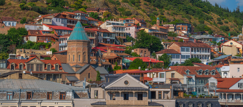 Old Tbilisi city panorama with Surb Gevorg church and traditional houses in Georgia
