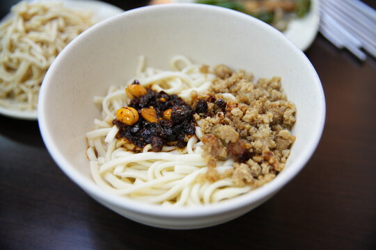Taiwanese dry noodles topped with minced pork and chili paste.