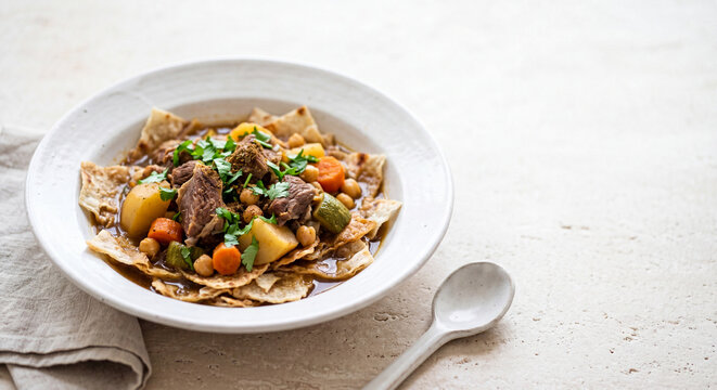 Traditional Qatari Thareed Lamb and Rigag Flatbread Stew Presentation